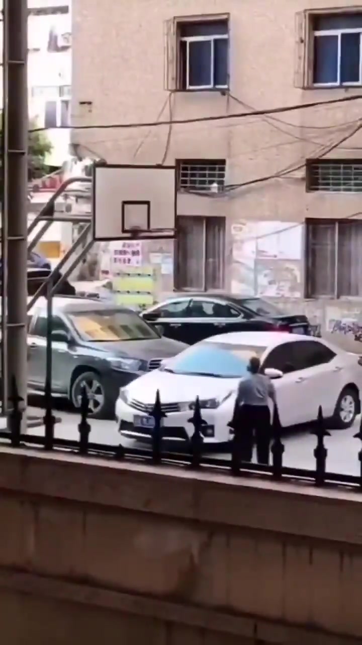 大爷在小区篮球场投篮砸到小轿车你站哪一边